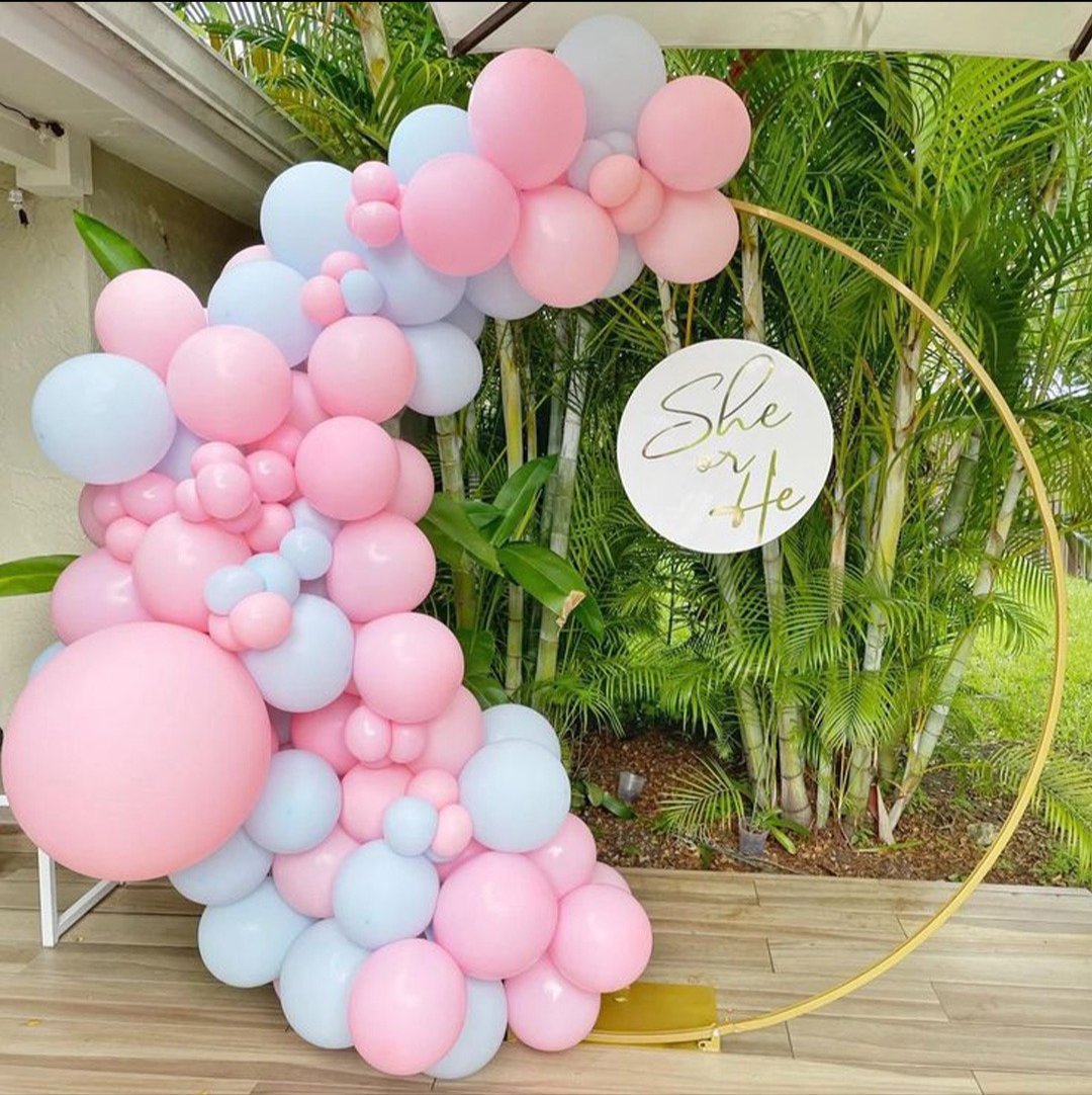 Pink and blue gender reveal balloon ring outdoors